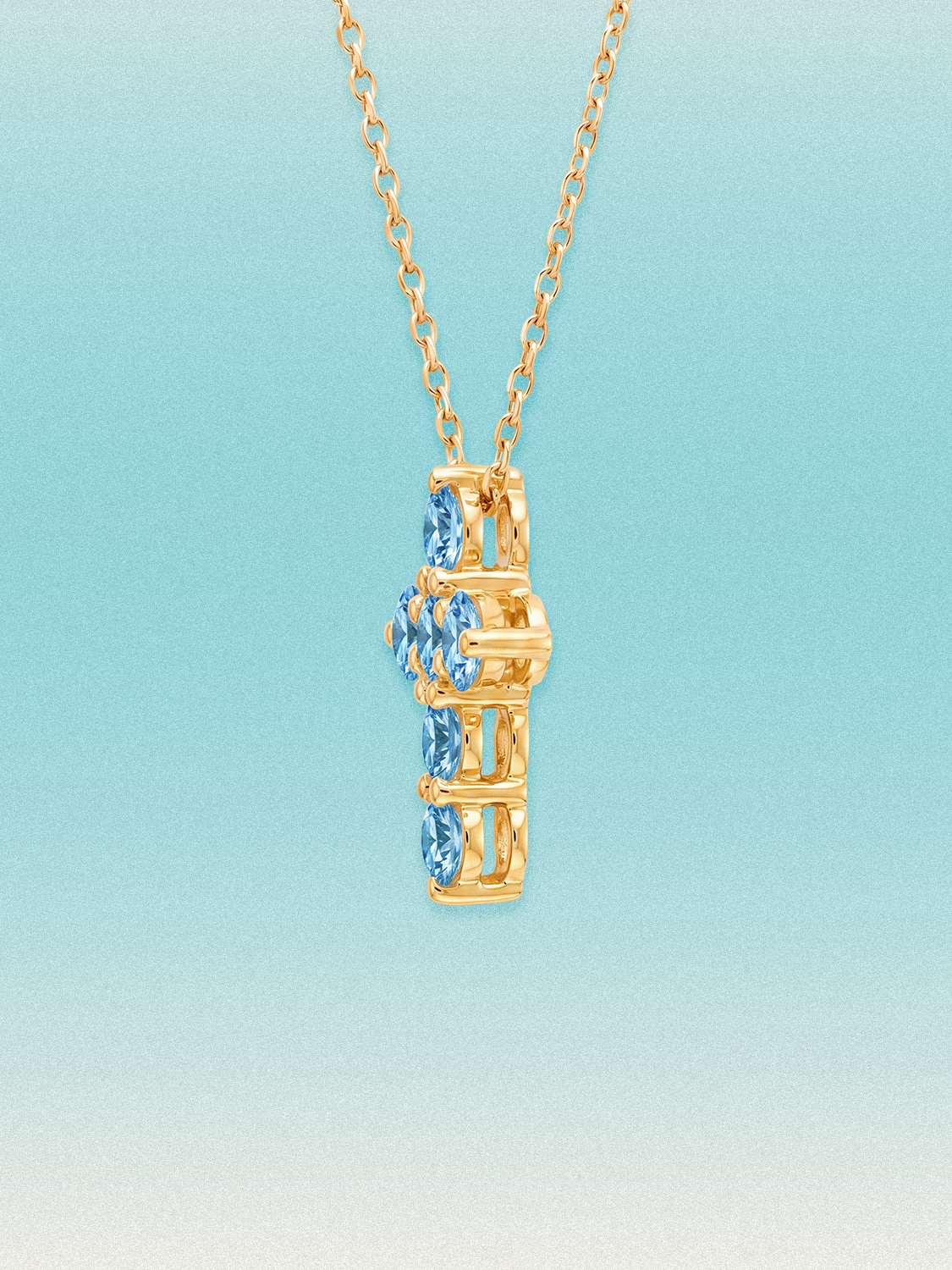 Close-up of the Bow Tie Lab Diamonds 1.55 ctw 7-stone Fancy Blue cross pendant — seven round blue lab-grown diamonds in a cross-shaped setting.
