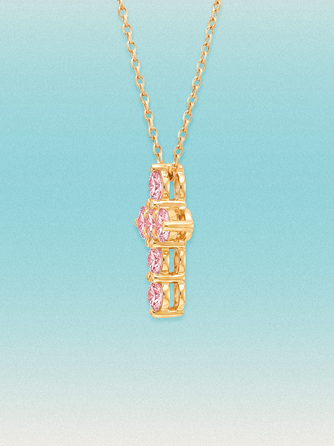 Close-up of the Bow Tie Lab Diamonds Fancy Pink cross pendant: seven round pink lab-grown diamonds, 1.55 ctw total, in a cross-shaped setting.