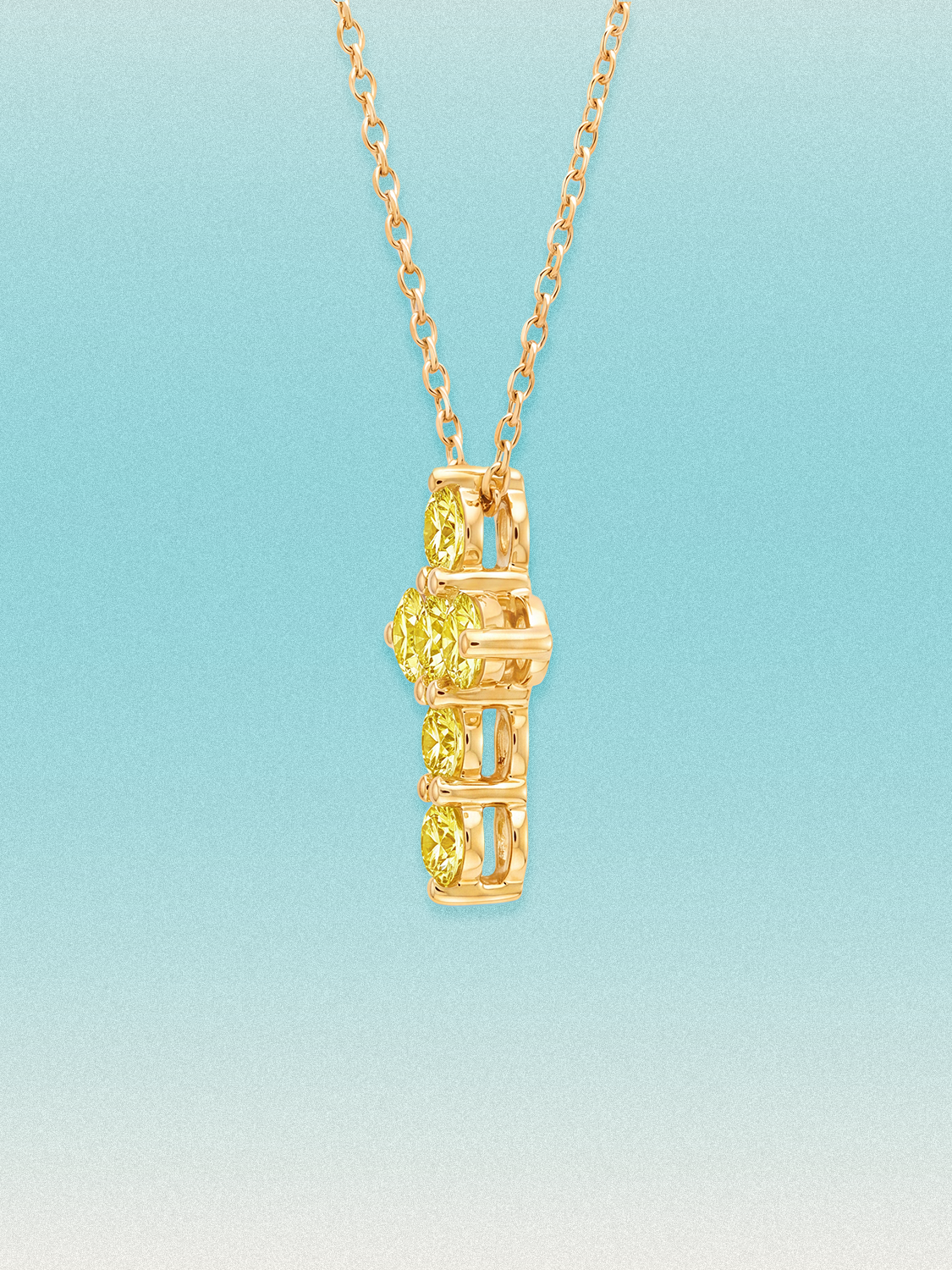Close-up of the Bow Tie Lab Diamonds 1.55 ctw 7-stone Fancy Yellow cross pendant — seven round yellow lab-grown diamonds in a cross-shaped setting.