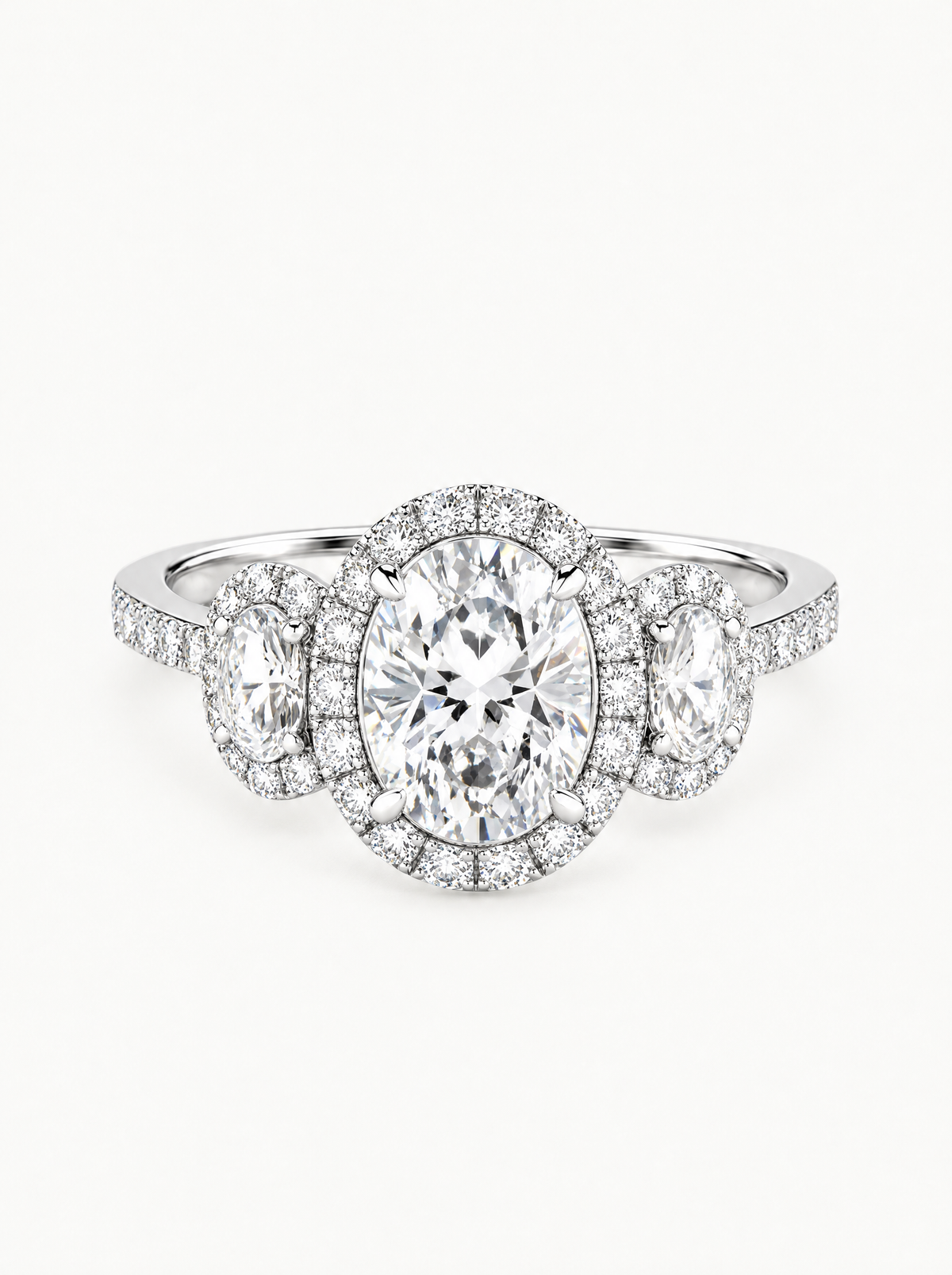 7.00 ctw Oval Three-Stone Halo Pave Lab-Grown Diamond Engagement Ring in 14K white gold, angled side view — Bow Tie Lab Diamonds