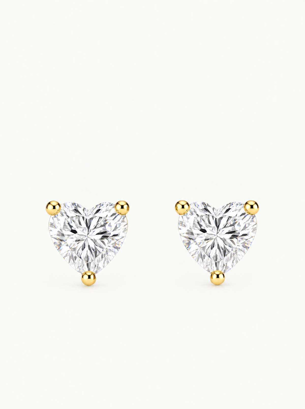 Heart Cut Lab-Grown Diamond Stud Earrings in 14K yellow gold, angled side view — Bow Tie Lab Diamonds