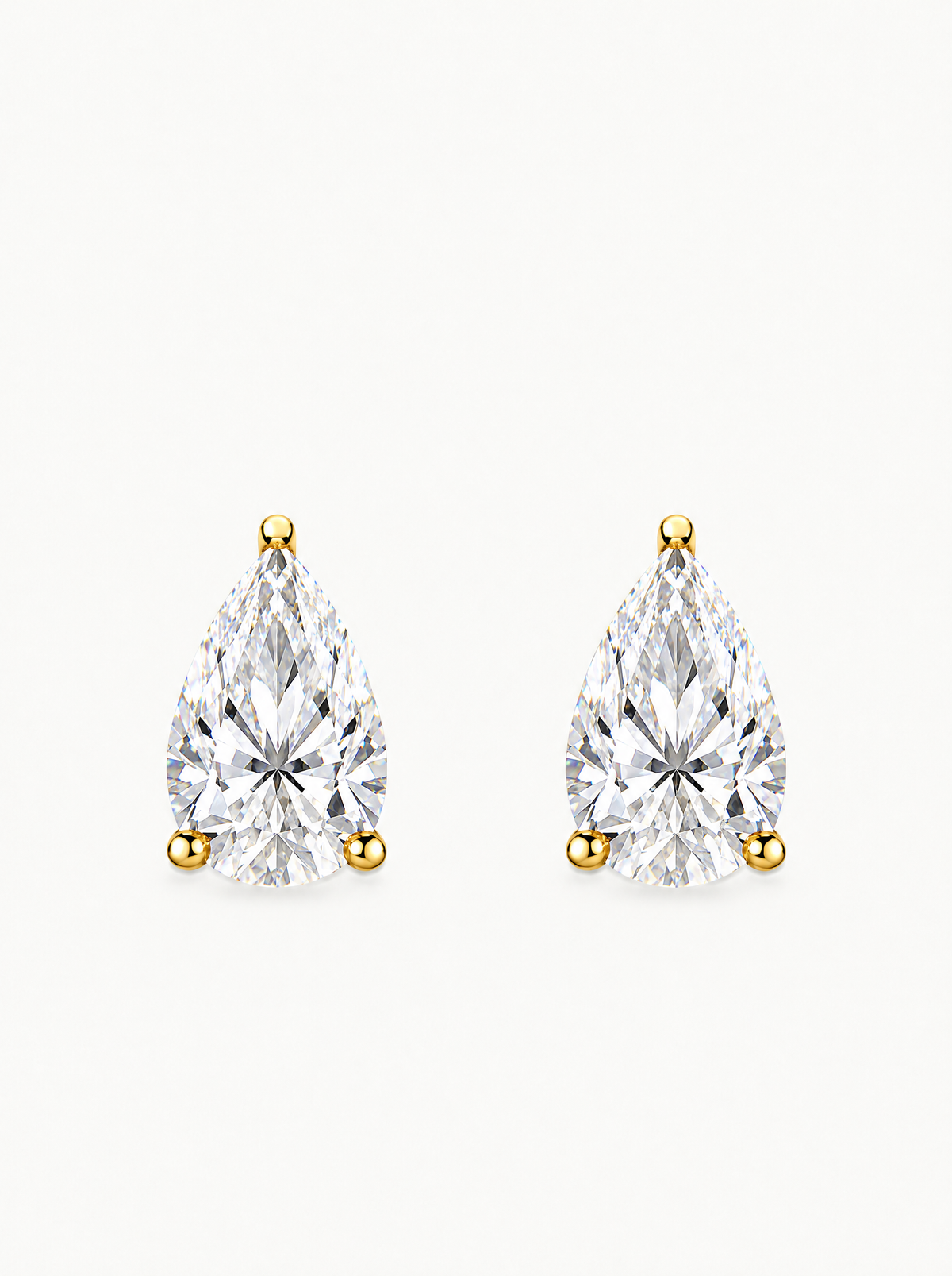 Pear Cut Lab-Grown Diamond Stud Earrings in 14K yellow gold, angled side view — Bow Tie Lab Diamonds