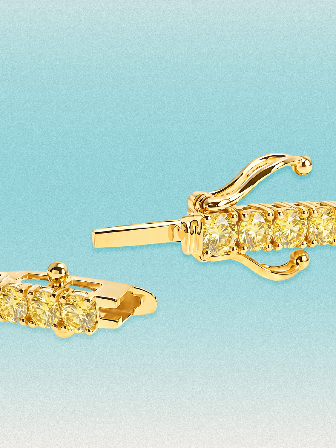 Clasp detail of a Bow Tie Lab Diamonds Fancy Yellow Round 4-Prong 7-inch lab-grown diamond tennis bracelet in 14K yellow gold.
