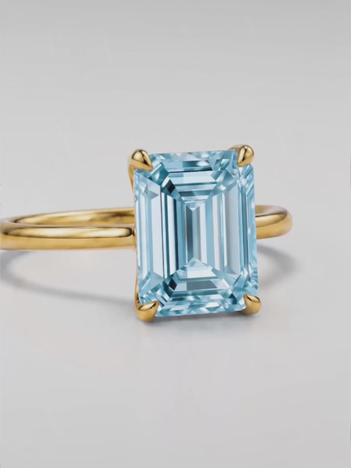 Load video: Video of the Fancy Blue Emerald Cut Solitaire Lab-Grown Diamond Engagement Ring, showing sparkle and movement — Bow Tie Lab Diamonds