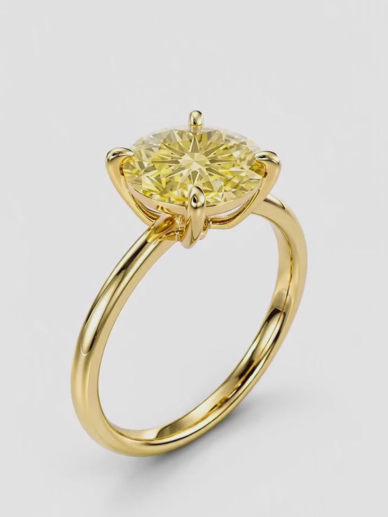 Video of the Fancy Yellow Round Cut 4-Prong Solitaire Lab-Grown Diamond Engagement Ring, showing sparkle and movement — Bow Tie Lab Diamonds