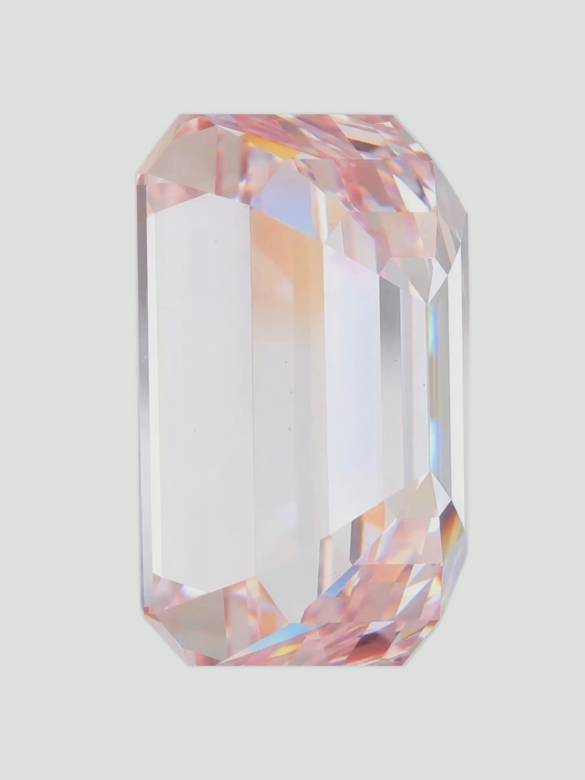 Load video: Rotating video of a fancy pink emerald cut lab-grown diamond showing its sparkle — Bow Tie Lab Diamonds